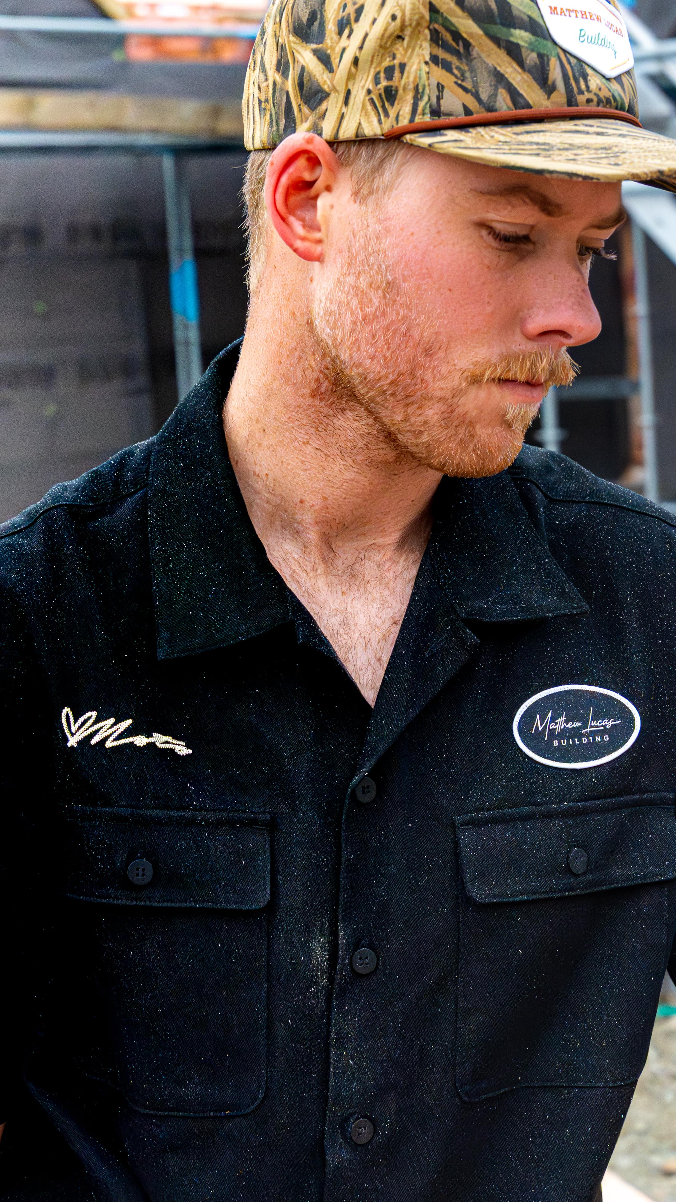 A Matthew Lucas Building carpenter in the team's blacks, signature embroidered on the chest